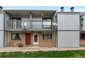 Exterior elevation of home featuring brick facade, balconies, and well maintained lawn at 544 Vance St, Lakewood, CO 80226