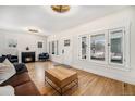 Cozy living room with a fireplace, hardwood floors, and lots of natural light at 595 N Lafayette St, Denver, CO 80218