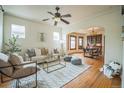 Bright living room with hardwood floors, area rug, modern furniture, and an open dining area at 3024 W Denver Pl, Denver, CO 80211