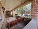 Inviting front porch featuring a charming wooden swing and brick accents, creating a cozy outdoor space at 3024 W Denver Pl, Denver, CO 80211