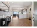 Inviting foyer featuring wood floors, arched doorways, and contemporary decor at 5310 Craftsman Dr, Parker, CO 80134