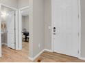 Bright entryway with white doors and modern hardware, leading to office and powder room at 5166 Trails Edge Ln, Castle Rock, CO 80104