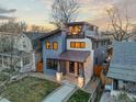 Stunning aerial view of a modern home with a rooftop terrace and manicured lawn at 3925 Winona Ct, Denver, CO 80212