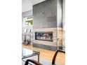Modern fireplace with a floor-to-ceiling tile surround in a bright and open living space at 3617 Shoshone St, Denver, CO 80211