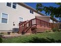 The back of the house shows a wooden deck accessible from the yard, offering outdoor living at 10966 Josephine St, Northglenn, CO 80233