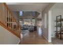 Bright living room with soaring ceilings, large windows, and hardwood floors at 9525 W Victoria Dr, Littleton, CO 80128