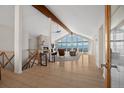 Spacious living room with vaulted ceilings, stone fireplace, hardwood floors, and mountain views at 12672 Rancho Ct, Conifer, CO 80433