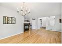 Open living area with hardwood floors, a fireplace, and staircase at 11367 S Blackthorn Ct, Parker, CO 80134
