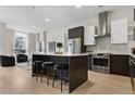 Well-appointed kitchen with stainless steel appliances, a central island, and a view to the living area at 2530 Lawrence St # Ra101, Denver, CO 80205