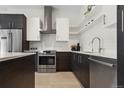 Modern kitchen featuring stainless steel appliances, sleek cabinetry, and bright subway tile backsplash at 2530 Lawrence St # Ra101, Denver, CO 80205