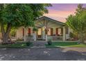Inviting front porch with vibrant shutters, decorative plants, and ample space for seating at 6480 W 60Th Ave, Arvada, CO 80003