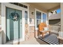 Cozy front porch with a welcome mat, wooden bench, and cheerful wreath adorning the entry door at 6021 Lynx Creek Cir, Erie, CO 80516
