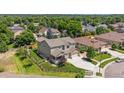 Spacious home with lush green landscaping, a fenced yard, and a large driveway at 3890 Tabor Ct, Wheat Ridge, CO 80033