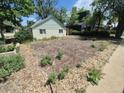 Landscaped front yard with garden, offering potential for outdoor enjoyment and curb appeal at 444 S Jersey St, Denver, CO 80224