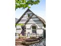 Charming home with unique architectural details, a cozy front porch, and a landscaped yard at 3375 W 37Th Ave, Denver, CO 80211