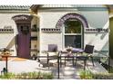 Inviting front porch with seating, a charming purple door, and manicured landscaping at 3375 W 37Th Ave, Denver, CO 80211