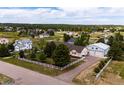Sprawling property featuring a home, detached garage, and fenced yard in a wooded community at 5685 Columbine Ridge Rd, Elizabeth, CO 80107