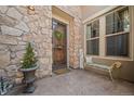 Charming front entrance with stone accents, a welcoming bench, and tasteful decorations at 2236 S Isabell Ct, Lakewood, CO 80228