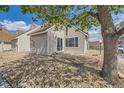 Private backyard area with mature tree and stone landscaping, perfect for outdoor relaxation at 2469 S Xanadu Way # A, Aurora, CO 80014