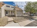 Inviting townhome featuring neutral siding, front walkway, and a touch of greenery at 2469 S Xanadu Way # A, Aurora, CO 80014