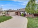 Inviting ranch home with a curved driveway, two-car garage, and brick accents at 236 E Fair Ln, Centennial, CO 80121
