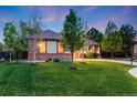Beautiful home with brick accents, mature trees, and a lush green lawn at 236 E Fair Ln, Centennial, CO 80121