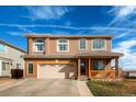 Charming two-story house with a two car garage and a well-maintained lawn at 20341 E 48Th Pl, Denver, CO 80249