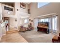 Bright living room featuring vaulted ceilings, natural light, and elegant décor at 20341 E 48Th Pl, Denver, CO 80249