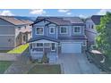 Beautiful two-story home with solar panels, covered porch, and well-kept lawn at 8489 S Quay St, Littleton, CO 80128