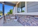 Cozy front porch with stone accents, seating, and great natural light at 8489 S Quay St, Littleton, CO 80128