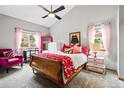 Cozy bedroom with a sloped ceiling, ample natural light, and playful decor at 13313 Cherry Cir, Thornton, CO 80241