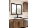 Close up of modern kitchen details with dark cabinets and an undermount sink at 7290 Timber Trail Rd, Evergreen, CO 80439