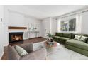 Cozy living room features a fireplace, modern furniture, and natural light for comfortable living at 6011 Yarrow St # I, Arvada, CO 80004