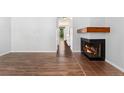 Elegant fireplace detail and wood-look floors create a warm and inviting atmosphere in this spacious home at 6011 Yarrow St # I, Arvada, CO 80004