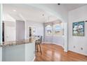 Bright breakfast nook features a bay window, hardwood floors, and views of the backyard at 10071 E 142Nd Ave, Brighton, CO 80602