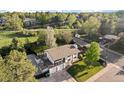 Aerial view of a two-story home with a spacious yard, mature trees, and a two-car garage at 794 W Elati Cir, Littleton, CO 80120