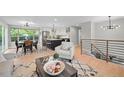 Bright living room with an open layout, hardwood floors, and modern furnishings at 794 W Elati Cir, Littleton, CO 80120