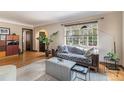 Cozy living room with hardwood floors, large windows, and stylish furnishings at 1423 Dahlia St, Denver, CO 80220