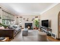 Bright living room featuring a fireplace, hardwood floors and large windows at 1423 Dahlia St, Denver, CO 80220