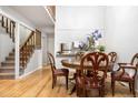 Open dining room features hardwood floors and is adjacent to the kitchen and living area at 11689 Elk Head Range Rd, Littleton, CO 80127