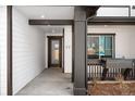 Inviting front porch area with a glass front door, dark trim, and a stylish planter at 8530 W 52Nd Ave # C2, Arvada, CO 80002