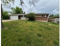 Charming single-Gathering home with a lush green lawn and mature trees at 12058 E Virginia Pl, Aurora, CO 80012