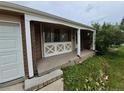 Inviting front porch with decorative detailing, and an attached garage at 12058 E Virginia Pl, Aurora, CO 80012