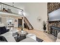 Bright open-concept living room with vaulted ceilings, fireplace, wood floors and plenty of natural light at 324 Wright St # 304, Lakewood, CO 80228