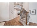 Grand foyer with a curved staircase, hardwood floors, and elegant decor at 21416 E Ottawa Cir, Aurora, CO 80016