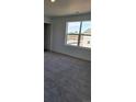 Sunlit bedroom features plush carpeting and a large window offering neighborhood views at 15296 Fillmore St, Thornton, CO 80602