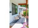 Cozy front porch featuring comfortable seating, a patterned rug, and decorative plants for a welcoming outdoor space at 2571 S Cherokee St, Denver, CO 80223