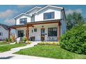 Charming two-story home with modern farmhouse appeal, a welcoming porch and well-manicured landscaping at 2571 S Cherokee St, Denver, CO 80223