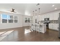 Bright and airy kitchen featuring a large island, stainless appliances, and white cabinetry at 4578 Copeland Cir # 203, Highlands Ranch, CO 80126
