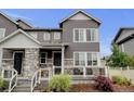 Charming gray two-story home with stone accents and a cozy front porch at 3765 W 88Th Ct, Westminster, CO 80031